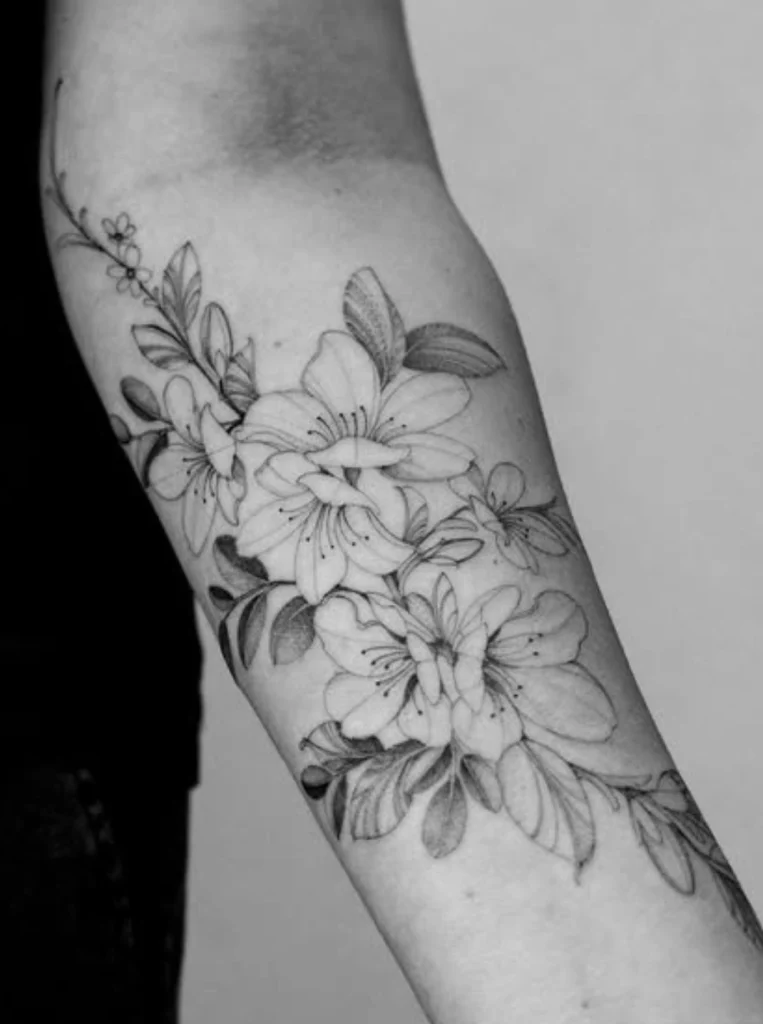 Elegant fine line tattoo of lilies with intricate botanical details created at Melbourne's premier tattoo studio